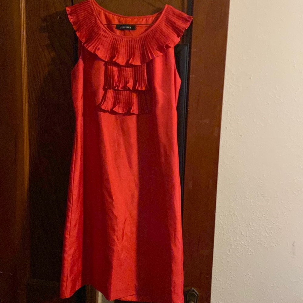 Bright orange sleeveless dress.